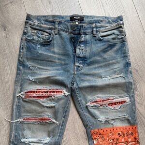 Amiri Stylish Distressed Blue Jeans with Orange and Red Accents